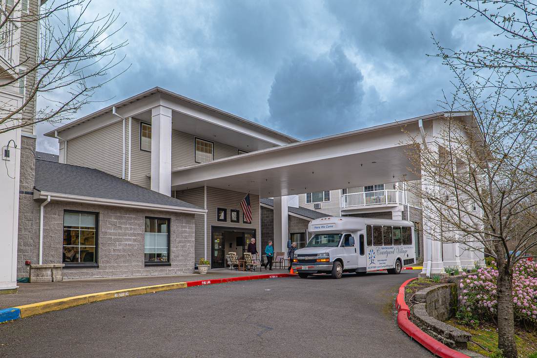 Courtyard Village building with a covered entrance and the community shuttle
