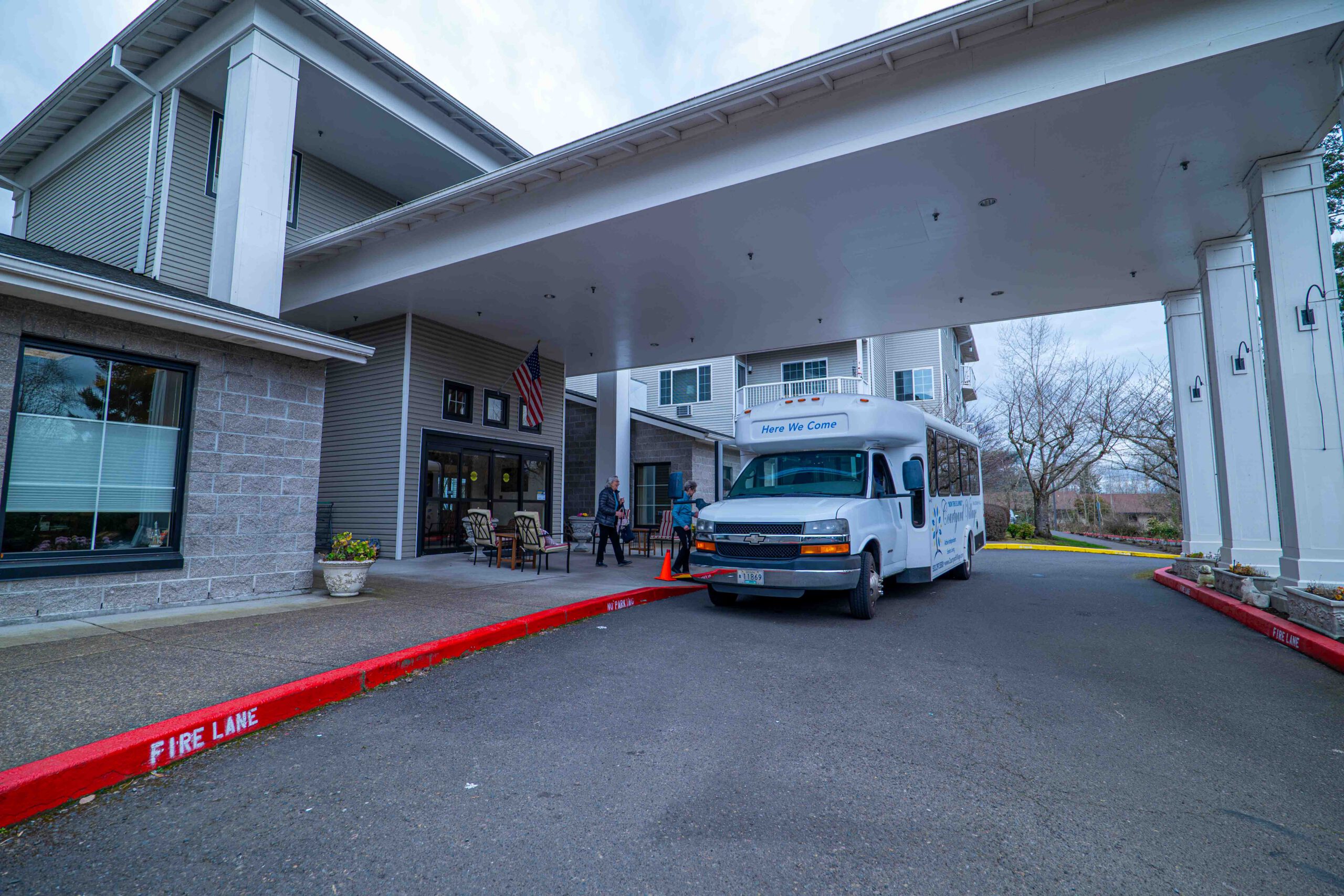 Covered front entrance with the community shuttle bus