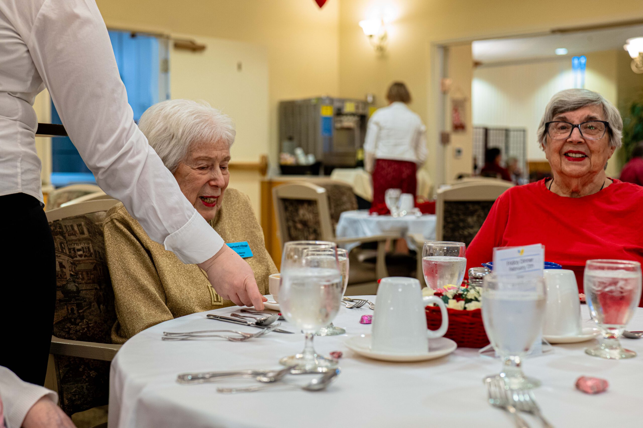 Residents enjoying a meal at a dining room table